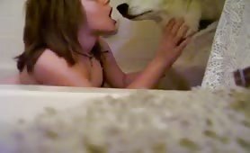 girl kissing dog